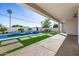 View of the luxurious backyard with an outdoor kitchen, pool with water feature, and modern design at 7325 E Virginia Ave, Scottsdale, AZ 85257