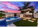 Backyard featuring pool, spa, outdoor kitchen, and covered patio at 7325 E Virginia Ave, Scottsdale, AZ 85257