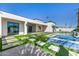Beautiful backyard showcasing a modern pool, spa, and artificial grass, ideal for outdoor relaxation at 7325 E Virginia Ave, Scottsdale, AZ 85257