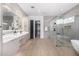Large bathroom with dual sinks, walk in shower, and a modern soaking tub at 7325 E Virginia Ave, Scottsdale, AZ 85257