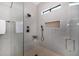 Modern bathroom featuring a glass enclosed shower with black fixtures and neutral tile surround at 7325 E Virginia Ave, Scottsdale, AZ 85257