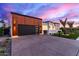 Sleek, modern home with black garage door, desert landscaping, and gated entry at 7325 E Virginia Ave, Scottsdale, AZ 85257