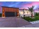 Modern home with wood clad garage, desert landscaping, and gated entry at 7325 E Virginia Ave, Scottsdale, AZ 85257