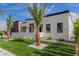 Contemporary home with artificial turf, desert landscaping, sleek black accents and modern minimalist design at 7325 E Virginia Ave, Scottsdale, AZ 85257