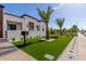 Home with a manicured lawn, desert landscaping, and well-maintained curb appeal, blending modern design with natural elements at 7325 E Virginia Ave, Scottsdale, AZ 85257