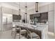 Modern kitchen with a large marble island, seating, and stainless steel appliances at 7325 E Virginia Ave, Scottsdale, AZ 85257