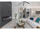 Living room featuring a modern fireplace, stylish decor, and plenty of natural light at 7325 E Virginia Ave, Scottsdale, AZ 85257