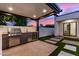 Backyard kitchen with stainless BBQ grill and beverage cooler under covered patio at 7325 E Virginia Ave, Scottsdale, AZ 85257