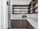Walk-in pantry with custom shelving, wine storage, and counter space; great for organization and entertaining at 7325 E Virginia Ave, Scottsdale, AZ 85257