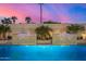 Inviting pool features elegant waterfall features, lush landscaping, and a serene twilight atmosphere at 7325 E Virginia Ave, Scottsdale, AZ 85257