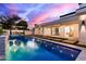 Backyard with a sparkling pool, hot tub, and outdoor kitchen area, ideal for entertaining guests at 7325 E Virginia Ave, Scottsdale, AZ 85257