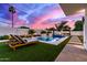 Relaxing backyard pool with lounge chairs and an outdoor kitchen, ideal for enjoying warm evenings at 7325 E Virginia Ave, Scottsdale, AZ 85257