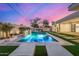 Luxurious outdoor pool and spa with a built-in grill, lush landscaping, and stylish lounge chairs at 7325 E Virginia Ave, Scottsdale, AZ 85257