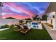 Backyard pool and lounge area showcasing lush landscaping and an outdoor kitchen, perfect for entertaining at 7325 E Virginia Ave, Scottsdale, AZ 85257