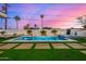 Stunning outdoor pool and spa area with lush landscaping, waterfalls, and comfortable lounge seating at 7325 E Virginia Ave, Scottsdale, AZ 85257