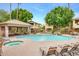 Inviting community pool and jacuzzi surrounded by lush landscaping and comfortable lounge seating for relaxing outdoors at 7401 W Arrowhead Clubhouse Dr # 2007, Glendale, AZ 85308