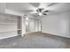 Bright and airy living room with modern shelving, ceiling fan, neutral carpet and walls, offering a comfortable living space at 7401 W Arrowhead Clubhouse Dr # 2007, Glendale, AZ 85308