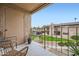 Cozy balcony with seating, offering a view of the well-maintained green space and covered parking at 7430 E Chaparral Rd # A243, Scottsdale, AZ 85250