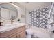 Charming bathroom showcasing a modern vanity with gold fixtures and geometric tile accents around the tub at 7430 E Chaparral Rd # A243, Scottsdale, AZ 85250