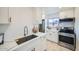 Well-equipped kitchen with white cabinets, modern appliances, and stylish fixtures at 7430 E Chaparral Rd # A243, Scottsdale, AZ 85250
