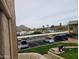 Scenic view of covered parking, a green lawn, and mountains in the distance at 7430 E Chaparral Rd # A243, Scottsdale, AZ 85250