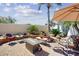 Spacious backyard with a stone patio, fire pit, and comfortable seating, surrounded by lush landscaping at 7705 E Doubletree Ranch Rd # 36, Scottsdale, AZ 85258