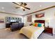 Spacious bedroom with a ceiling fan and a cozy seating area with a TV at 7705 E Doubletree Ranch Rd # 36, Scottsdale, AZ 85258