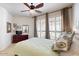 Comfortable bedroom with plantation shutters, ceiling fan, and dresser at 7705 E Doubletree Ranch Rd # 36, Scottsdale, AZ 85258