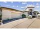Elegant home showcasing a spacious driveway leading to a two-car garage and desert landscaping at 7705 E Doubletree Ranch Rd # 36, Scottsdale, AZ 85258