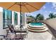 Inviting outdoor patio with comfortable seating under an umbrella, overlooking the pool and yard at 7705 E Doubletree Ranch Rd # 36, Scottsdale, AZ 85258