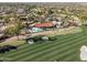 Aerial shot of a home with a pool on a golf course showcasing lush green grass at 8262 E Vista De Valle --, Scottsdale, AZ 85255