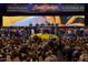 View of Barrett Jackson car auction filled with crowds of people bidding on a yellow sports car at 8262 E Vista De Valle --, Scottsdale, AZ 85255