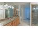 Bathroom boasts granite counters, custom lighting and cabinetry, along with a large mirror and shower at 8262 E Vista De Valle --, Scottsdale, AZ 85255