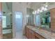 Bathroom with granite counters, large mirror, custom lighting, and a shower and bath at 8262 E Vista De Valle --, Scottsdale, AZ 85255