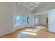 Bedroom boasts hardwood floors, cathedral ceiling with fan, bay window, and mirrored closet doors at 8262 E Vista De Valle --, Scottsdale, AZ 85255
