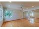 Spacious bedroom features hardwood floors, a ceiling fan, large windows, and sliding mirror door closet at 8262 E Vista De Valle --, Scottsdale, AZ 85255