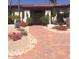 Inviting front entrance with a brick pathway, mature trees, and wrought iron door at 8262 E Vista De Valle --, Scottsdale, AZ 85255