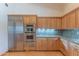 This kitchen features stainless steel appliances including a built-in oven and custom wood cabinetry at 8262 E Vista De Valle --, Scottsdale, AZ 85255