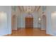 Elegant living room with tall ceilings, a chandelier, and wood flooring at 8262 E Vista De Valle --, Scottsdale, AZ 85255