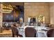 Restaurant interior with round table setting, neutral colored walls, and an elegant chandelier at 8262 E Vista De Valle --, Scottsdale, AZ 85255