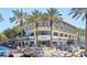 Attractive shopping center with upscale stores and palm trees at entrance with active people walking by at 8262 E Vista De Valle --, Scottsdale, AZ 85255