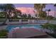 Sparkling swimming pool with integrated spa, surrounded by lush landscaping and mature trees at 8262 E Vista De Valle --, Scottsdale, AZ 85255