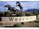 West World equestrian statue with three black horses rearing up next to a branded sign at 8262 E Vista De Valle --, Scottsdale, AZ 85255