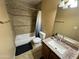 Bathroom featuring a tub with shower, vanity with granite countertop, and earth tone tile at 8504 E Lindner Ave, Mesa, AZ 85209