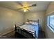 Cozy bedroom featuring a ceiling fan and natural light from the window at 8504 E Lindner Ave, Mesa, AZ 85209