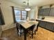 Cozy dining area features a square table and view of the backyard pool at 8504 E Lindner Ave, Mesa, AZ 85209