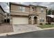 Two-story home with a two car garage and arched front entry on a cloudy day at 8504 E Lindner Ave, Mesa, AZ 85209
