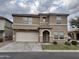 Two-story home with a two car garage and arched front entry on a cloudy day at 8504 E Lindner Ave, Mesa, AZ 85209