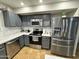Modern kitchen with stainless steel appliances and gray cabinets at 8504 E Lindner Ave, Mesa, AZ 85209