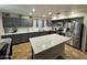Modern kitchen with stainless steel appliances, a center island, and gray cabinets at 8504 E Lindner Ave, Mesa, AZ 85209